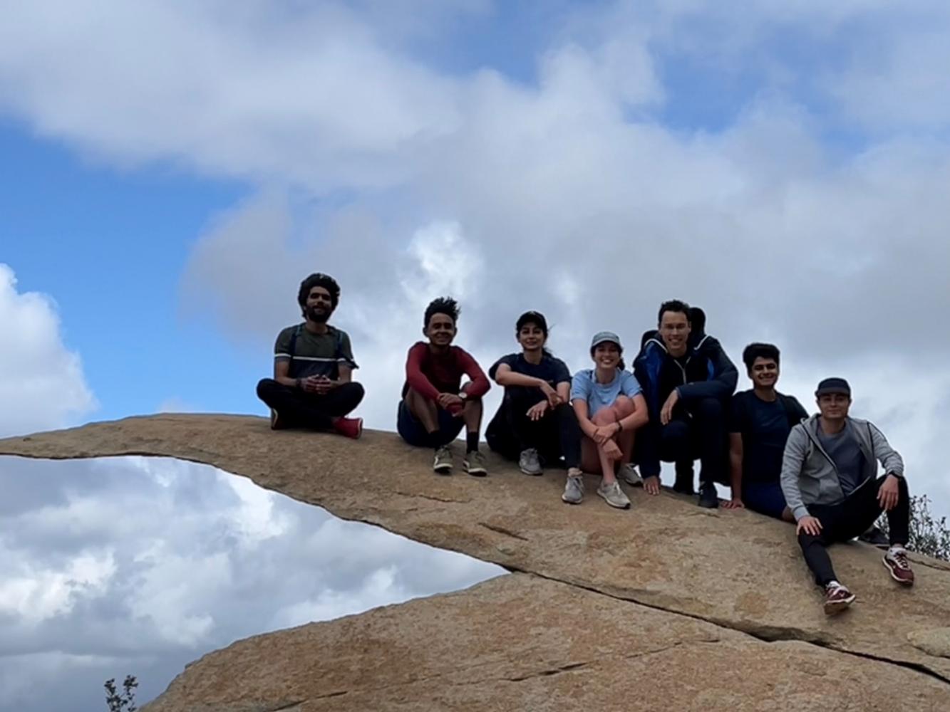 Picture of seven RoboGrads members sitting on Potato Chip Rock at Mount Woodson